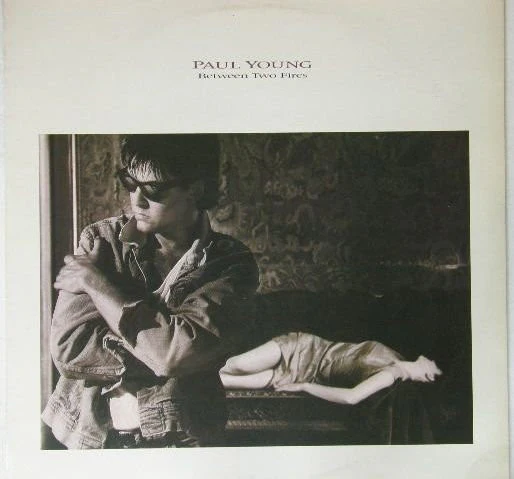Paul Young – Between Two Fires (E/VG+)